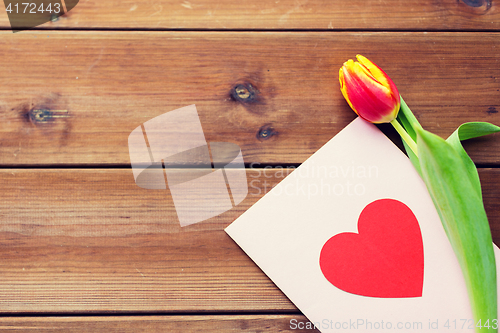 Image of close up of flowers and greeting card with heart