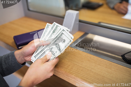 Image of hands with money at bank or currency exchanger