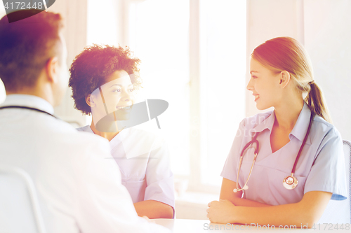 Image of group of happy doctors meeting at hospital office