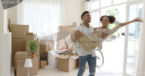 Image of Ecstatic young couple celebrating their new home