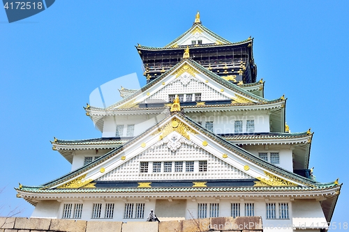 Image of Osaka castle tower closeup with blue sky