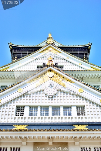 Image of Osaka castle tower closeup with blue sky