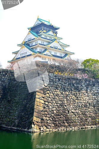 Image of Osaka castle tower and stone moat
