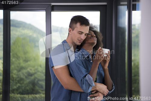 Image of romantic happy young couple relax at modern home indoors