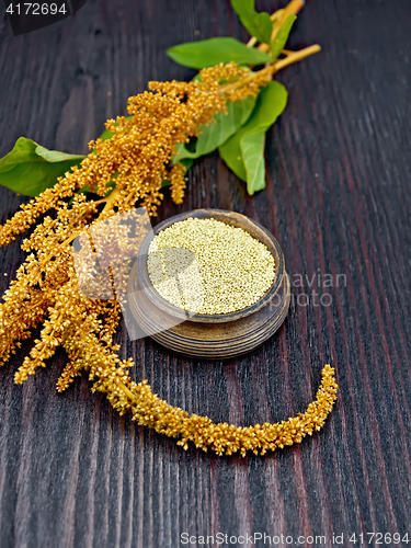 Image of Groats amaranth in clay bowl on board