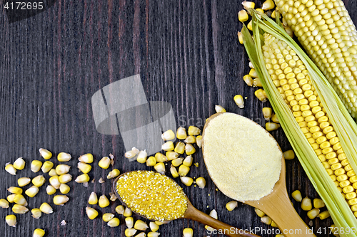 Image of Flour and grits corn in spoons on dark wooden board