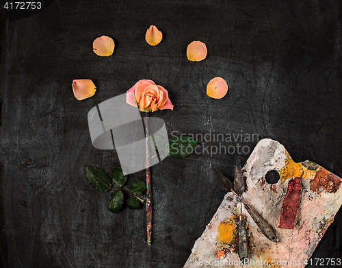 Image of paint brushes and tubes of oil paints on wooden background