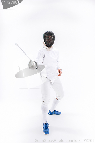 Image of Man wearing fencing suit practicing with sword against gray