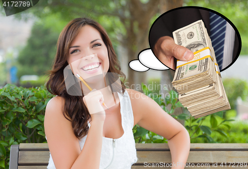 Image of Thoughtful Young Woman with Hand Holding Stack of Money Inside T