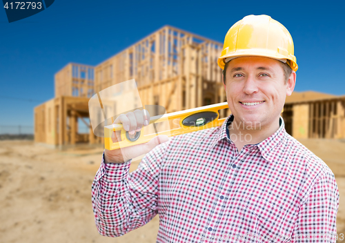 Image of Smiling Male Contractor in Hardhat Holding Blueprints  and Level