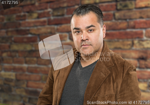 Image of Handsome Young Hispanic Male Headshot Portrait Against Brick Wal