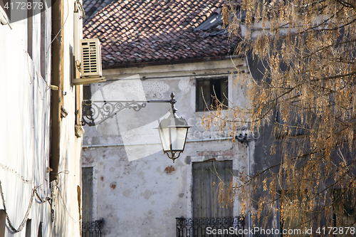 Image of Old street lantern mounted on the wall of a building