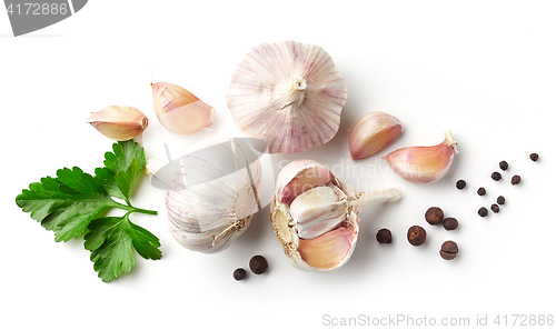 Image of garlic, parsley and pepper on white background