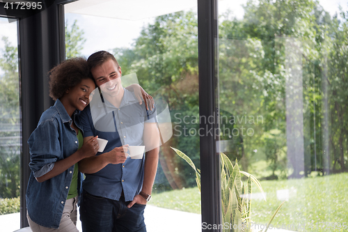 Image of romantic happy young couple relax at modern home indoors