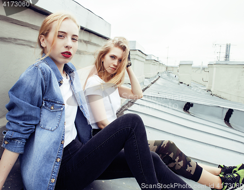 Image of Two teenage girls infront of university building smiling, having fun traveling europe, lifestyle people concept 