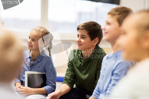 Image of group of happy kids or friends learning at school
