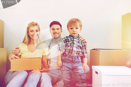 Image of happy family with boxes moving to new home