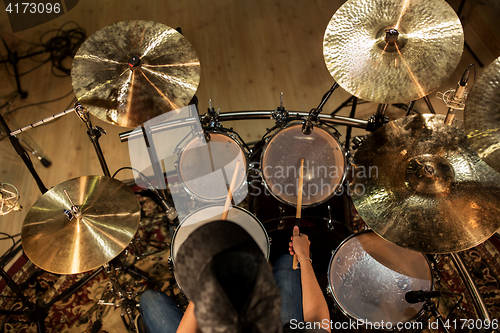 Image of male musician playing drums and cymbals at concert