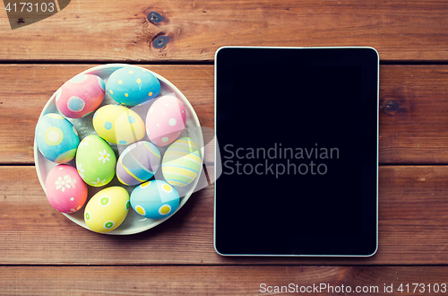 Image of close up of easter eggs and blank tablet pc