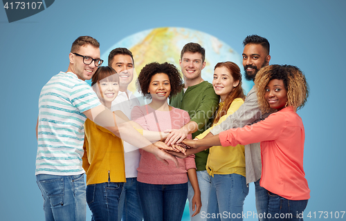 Image of international group of happy people holding hands