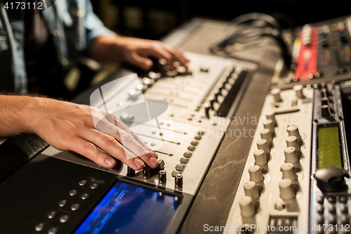 Image of man using mixing console in music recording studio