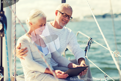 Image of senior couple with tablet pc on sail boat or yacht