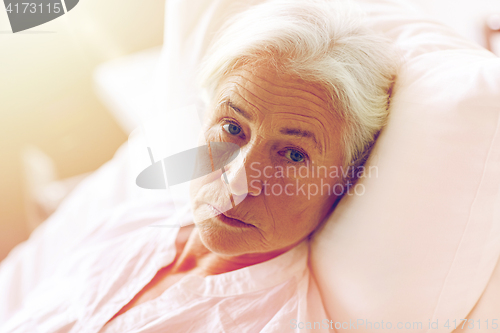 Image of senior woman patient lying in bed at hospital ward