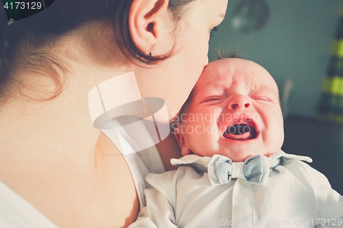 Image of Mother holding crying baby