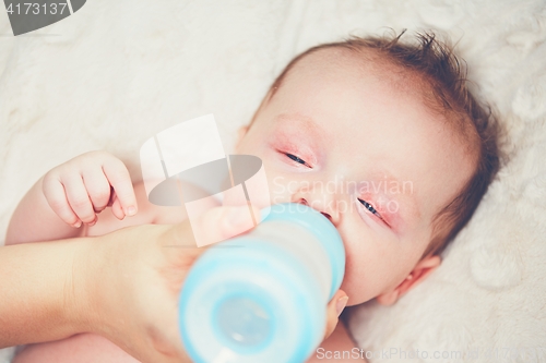 Image of Hungry baby drinking milk
