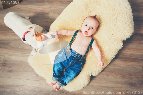 Image of Little boy and dog at home