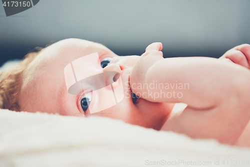 Image of Baby with hand in mouth