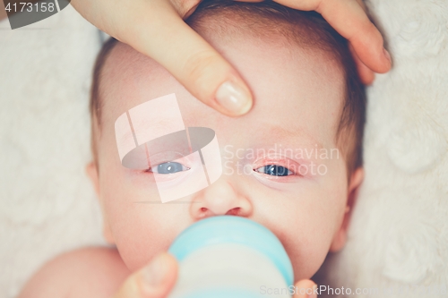 Image of Hungry baby drinking milk