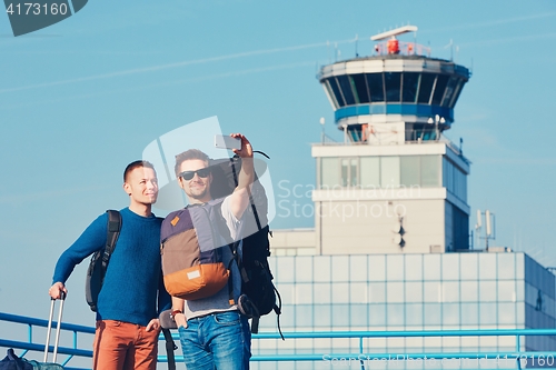 Image of Travelers taking a selfie at the airport