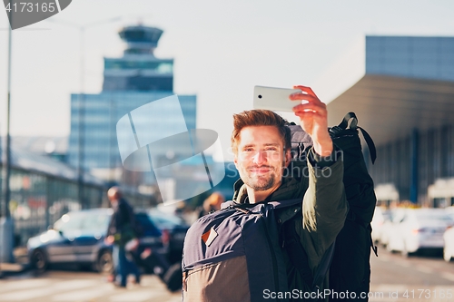 Image of Traveler taking a selfie at the airport