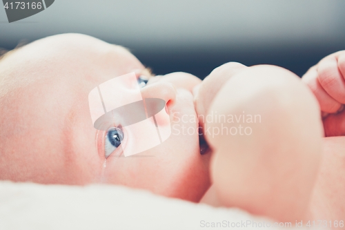 Image of Baby with hand in mouth