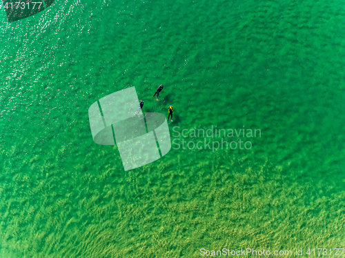 Image of Surfers Waiting Waves on the Surface of the Ocean