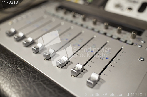 Image of music mixing console at sound recording studio