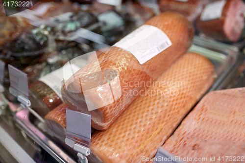 Image of ham at grocery store stall