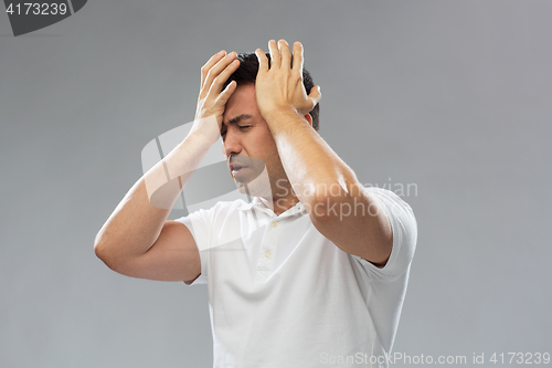 Image of unhappy man suffering from head ache