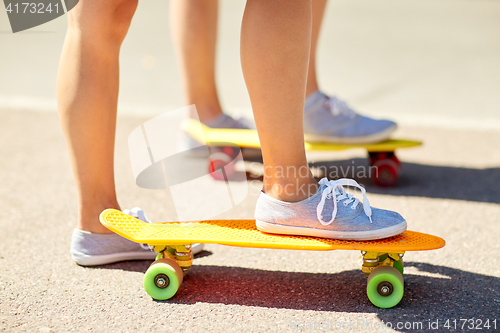 Image of close up of female feet riding short skateboard