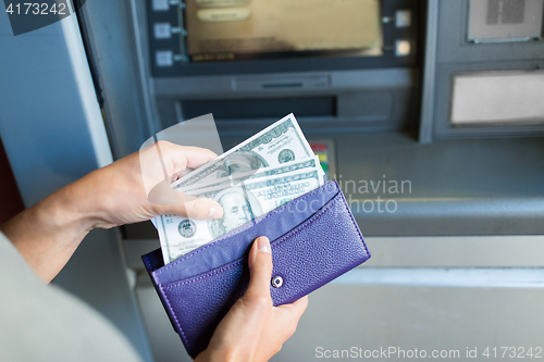 Image of close up of hand withdrawing money at atm machine