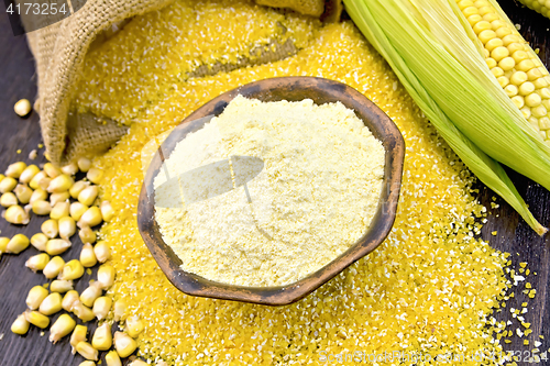 Image of Flour corn in bowl with grits and grains on dark board