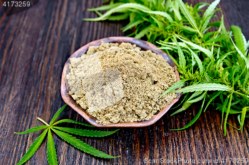 Image of Flour hemp in clay bowl with leaf on board