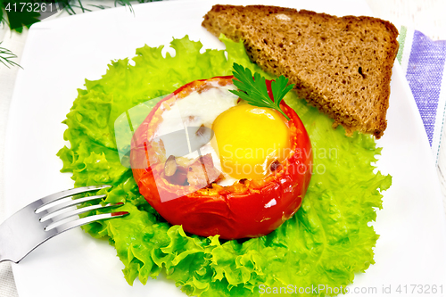 Image of Scrambled eggs in tomato on board