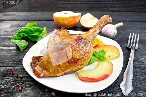 Image of Duck leg with apple and basil on board