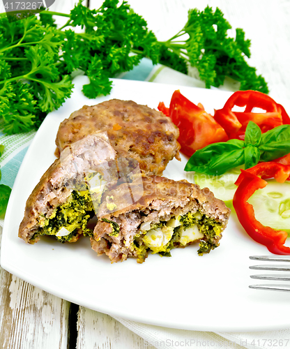 Image of Cutlets stuffed with vegetables in plate on light board