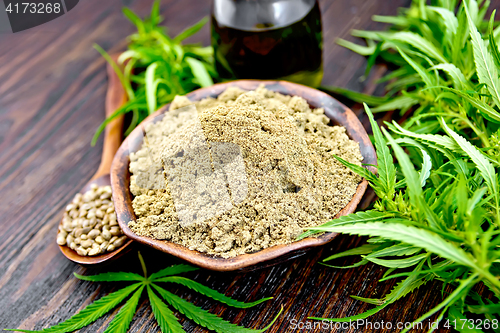 Image of Flour hemp in bowl with oil and spoon on board