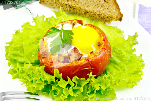 Image of Scrambled eggs in tomato and bread on board