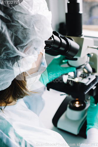 Image of Scientist working in laboratory with microscope