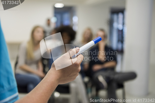 Image of close up of teacher hand with marker